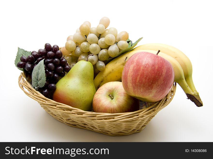 Fresh fruit in the basket onto white background. Fresh fruit in the basket onto white background