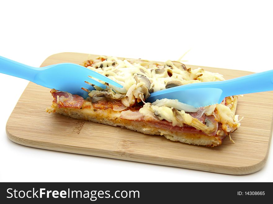 Pizza on edge board with plastic cutlery