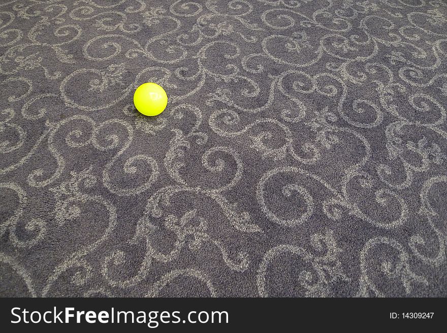 Small yellow ball on carpet. Small yellow ball on carpet