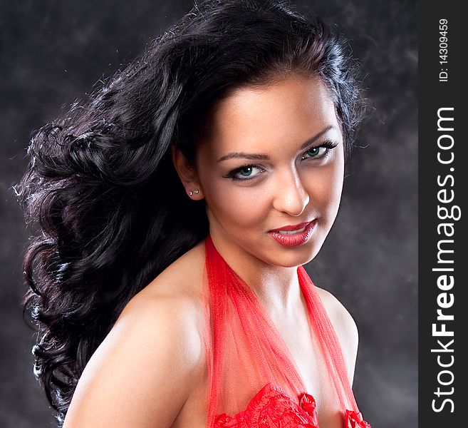 Beautiful glamorous woman with red dress, studio shot