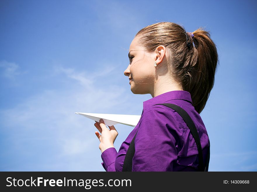 Young Businesswoman With Paper Plane In The Hand