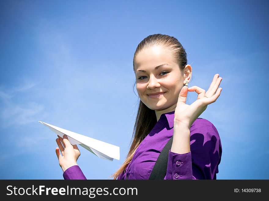 Young Caucasian Girl With Paper Plane In The Hand