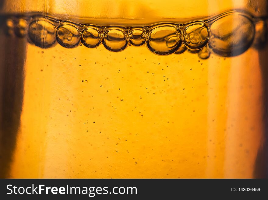 Closeup of medical liquid bubbles, golden colors background