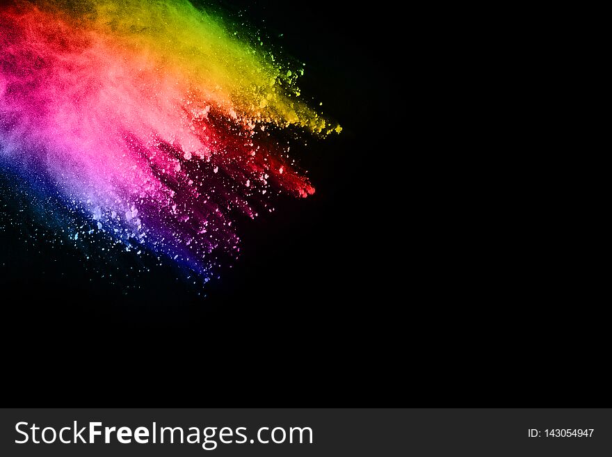 Multicolor powder explosion on black background.