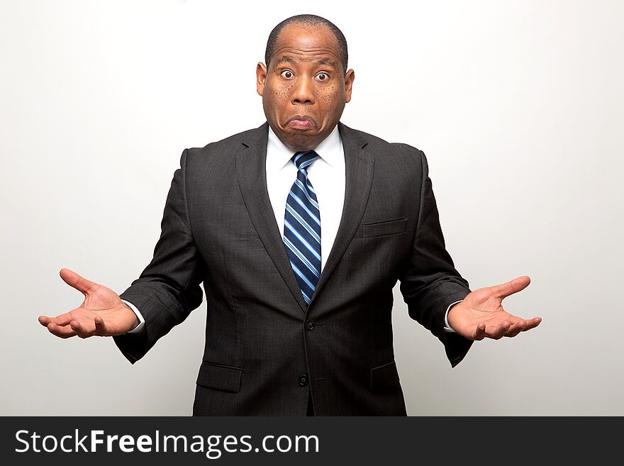 African American Business Man With Both Hands Signaling Confusion, Lack of Understanding