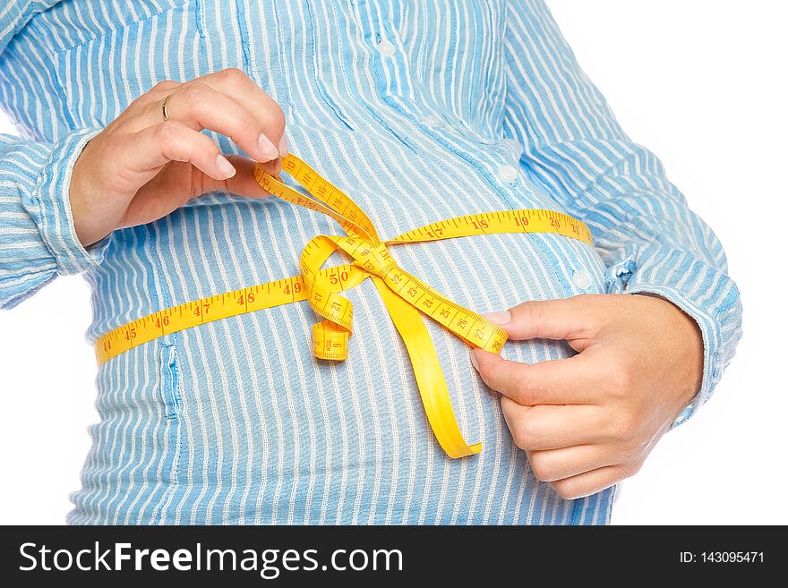 A Happy pregnant girl lies on white background