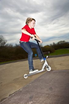 Boy Going Airborne With A Scooter Royalty Free Stock Photo