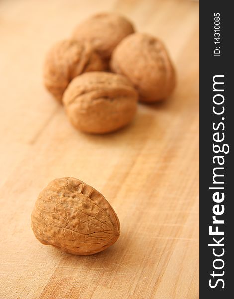 Walnuts close up isolated on brown wooden background