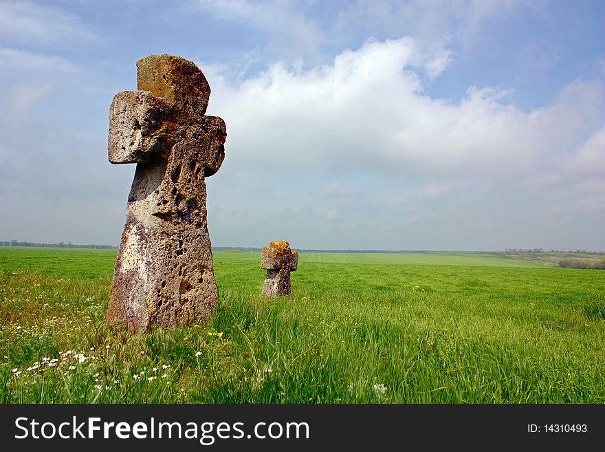 Ancient crosses, standing on the mound, a relic, more than 500 years, silent witnesses of history, ancient stones, the young green grass