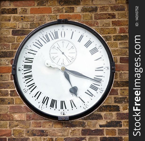 Old clock on a brick wall