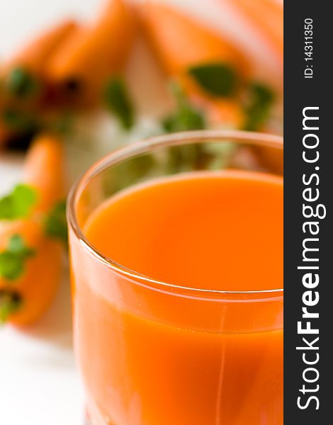 A glass of freshly squeezed carrot juice .