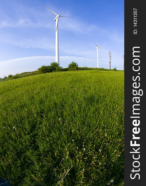 Wind turbine on the meadow shown by fisheye lens. Wind turbine on the meadow shown by fisheye lens