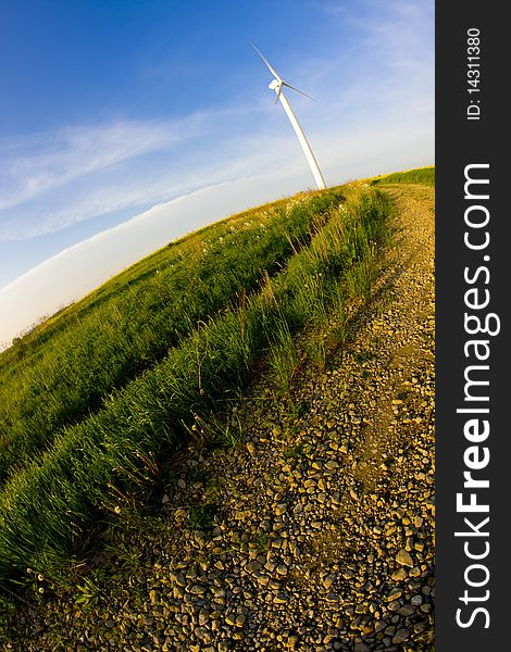 Wind turbine on the meadow shown by fisheye lens. Wind turbine on the meadow shown by fisheye lens