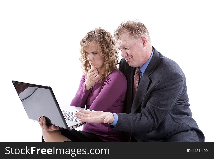 A couple is sitting with a computer and trying to figure out a problem. A couple is sitting with a computer and trying to figure out a problem.