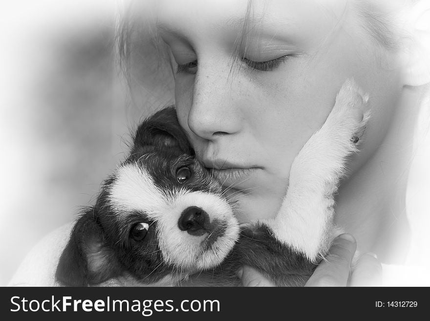 Beautiful black and white closeup of young girl and puppy. Beautiful black and white closeup of young girl and puppy