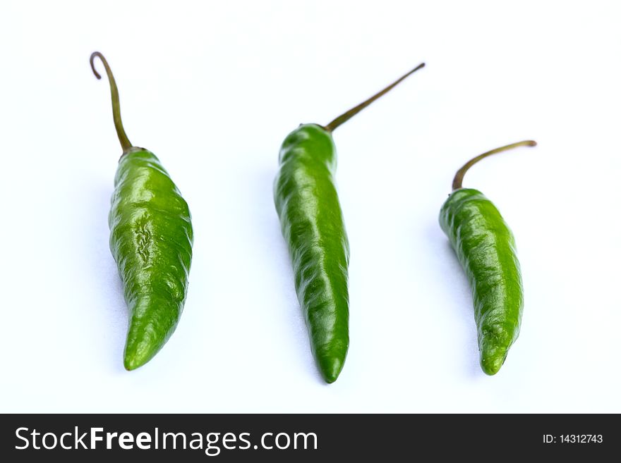 Three green chilli lined up