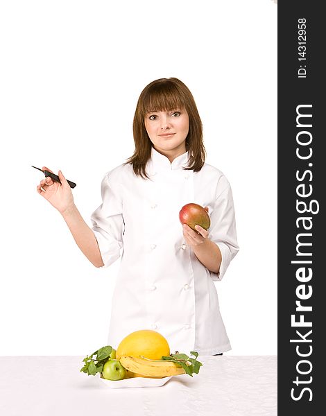 Cook girl holding a knife and a mango - isolated on white