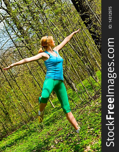 Young woman doing exercises in forest