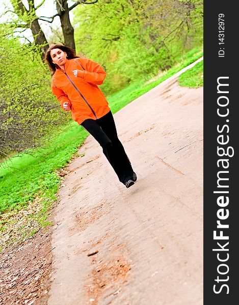 Young woman running in park. Young woman running in park