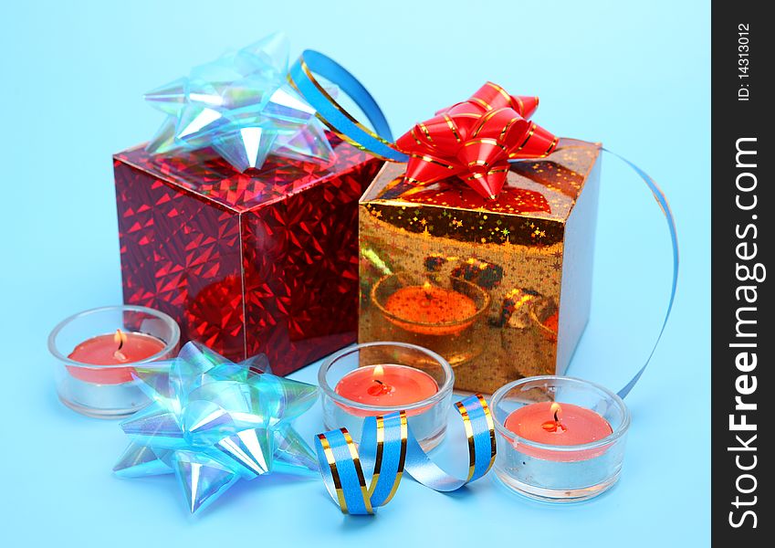 Gifts and candles on a blue background