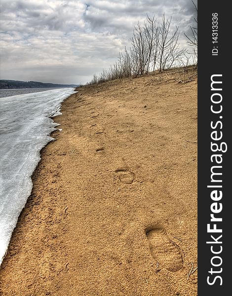 Early spring. Traces on sand along river bank. Russia, the Udmurt republic.