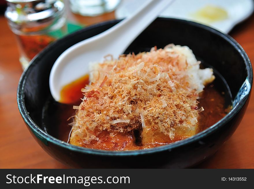 Japanese Agedashi tofu (deep fried beancurd) topped with Katsuobushi shavings. Japanese Agedashi tofu (deep fried beancurd) topped with Katsuobushi shavings