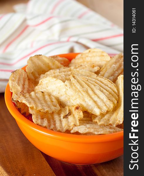 Potato Chips in Orange Bowl and kitchen Towel