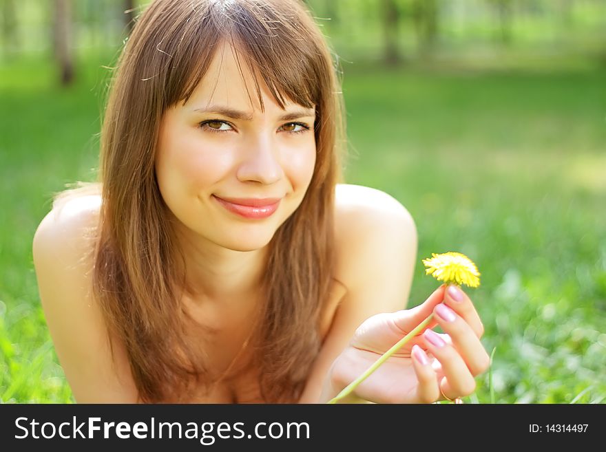 Beautiful young girl lying on grass