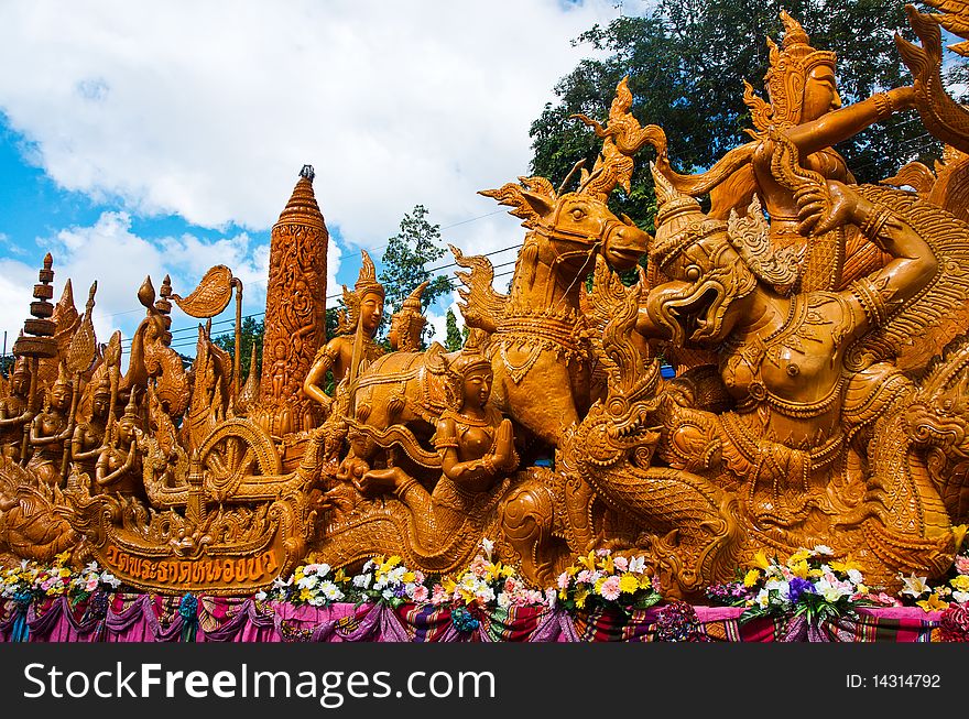 Carving candles to give as offerings to Buddha . Carving candles to give as offerings to Buddha .