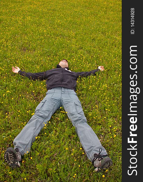 Man laying in grass and relaxing. Man laying in grass and relaxing