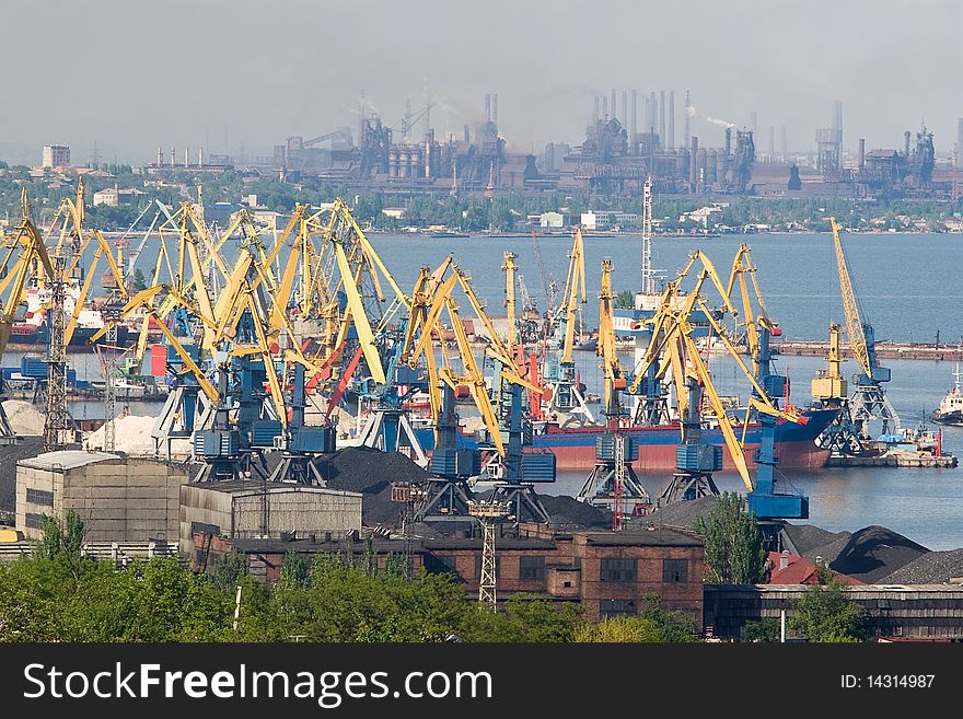 Industrial views of docks and big factory on the background. Heavy air polluiton is visible. Industrial views of docks and big factory on the background. Heavy air polluiton is visible.