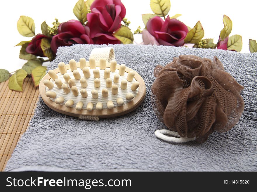 Massage brush with sponge and flowers on mat. Massage brush with sponge and flowers on mat