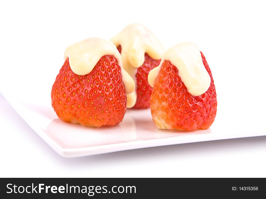 Strawberries with vanilla pudding on plate isolated
