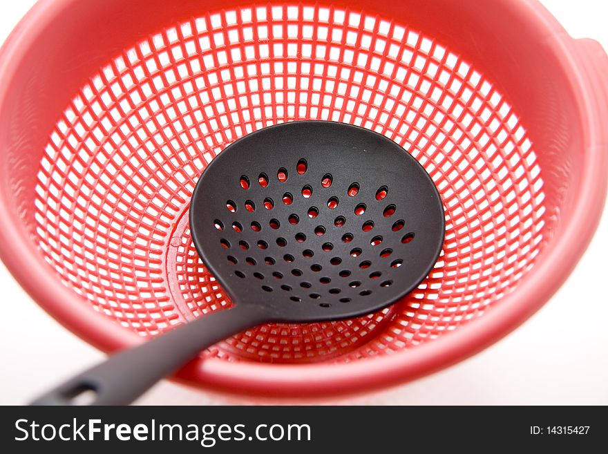 Ladle with kitchen sieve onto white background. Ladle with kitchen sieve onto white background