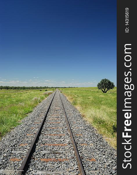 Train tracks central queensland disapearing into horizon on a nice pleasant warm day