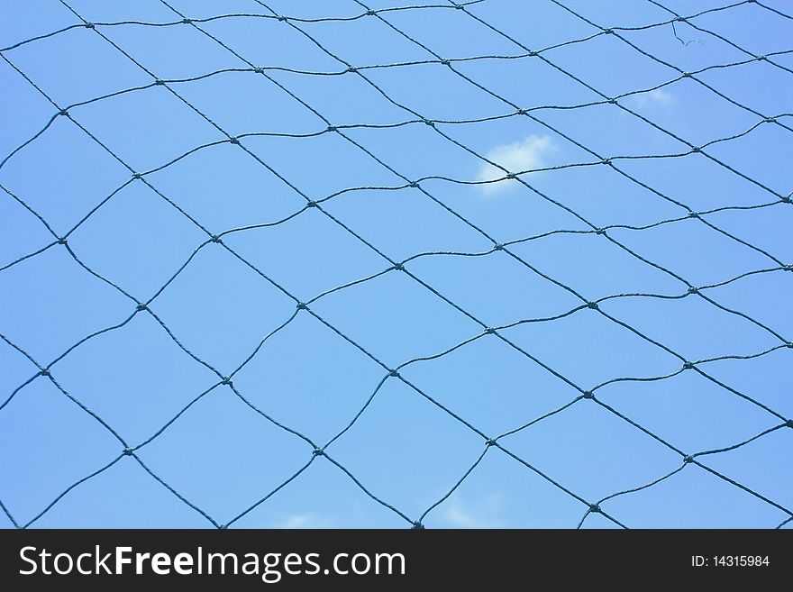 Old hemp fishing net against with sky