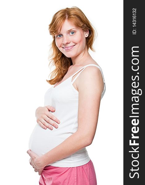 Young pregnant woman holding her hands on her tummy