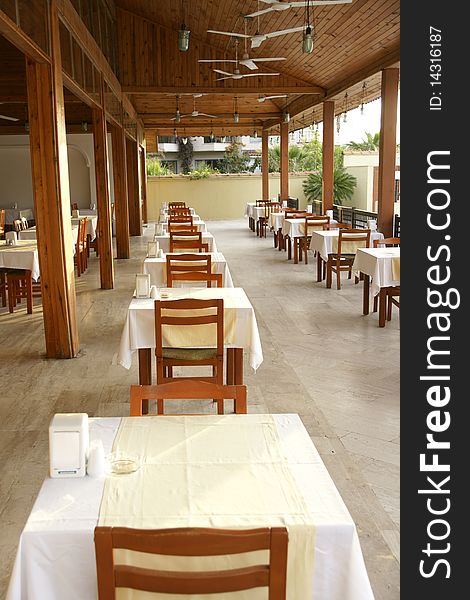 Little tables on a verandah in empty cafe. Little tables on a verandah in empty cafe