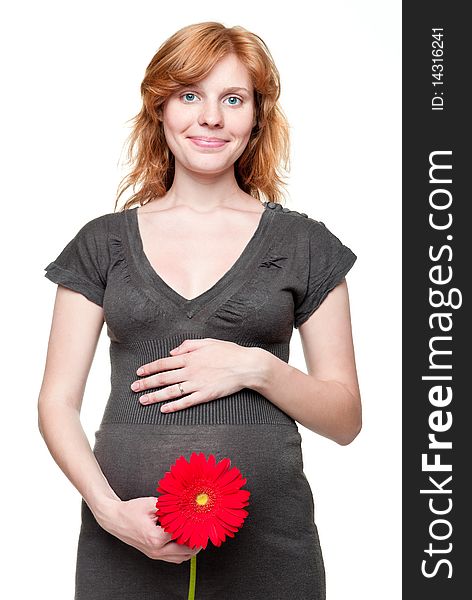 Young pregnant woman holding her hands on her tummy with red flower. Young pregnant woman holding her hands on her tummy with red flower