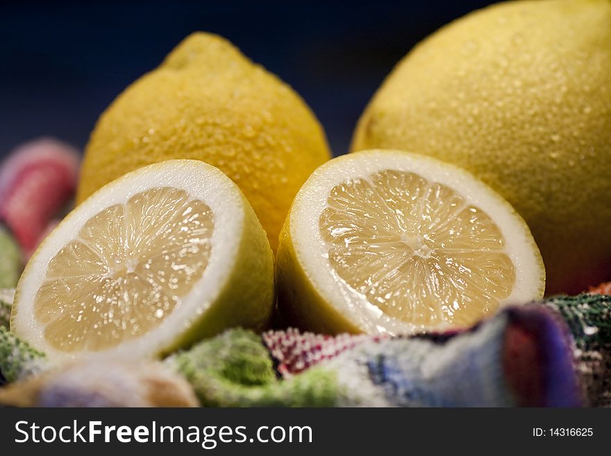 View of some yellow lemons sliced on top of table cloth. View of some yellow lemons sliced on top of table cloth.