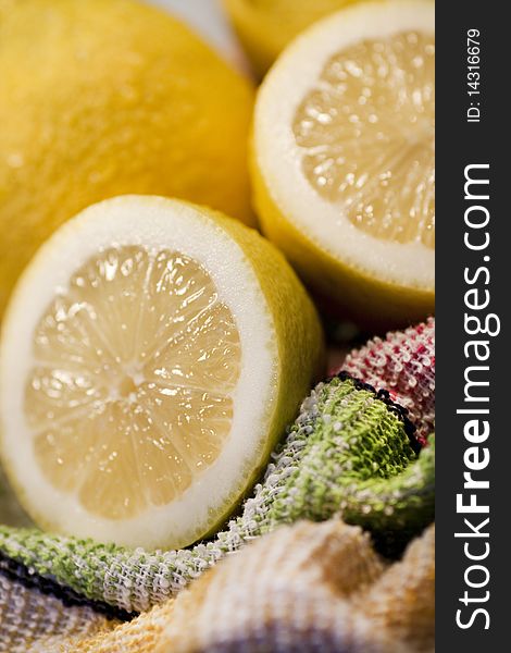 View of some yellow lemons sliced on top of table cloth. View of some yellow lemons sliced on top of table cloth.