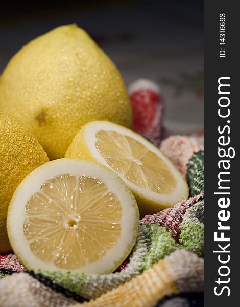 View of some yellow lemons sliced on top of table cloth. View of some yellow lemons sliced on top of table cloth.