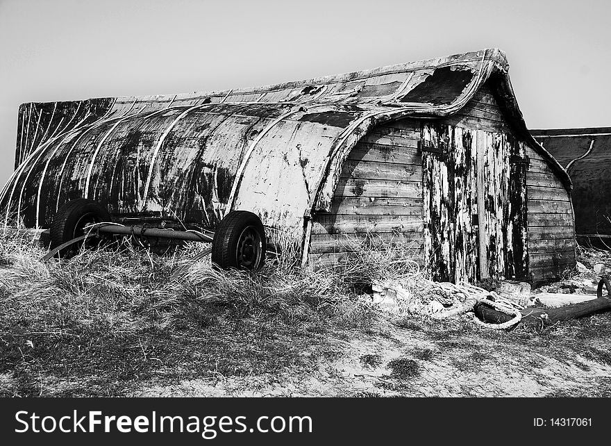 Black and white image of upturned boat sheds on Holy Island, Northumberland. Black and white image of upturned boat sheds on Holy Island, Northumberland