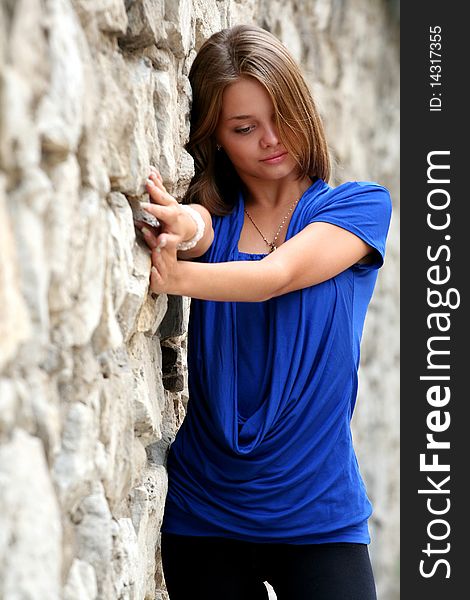 Image of a young girl posing near the wall