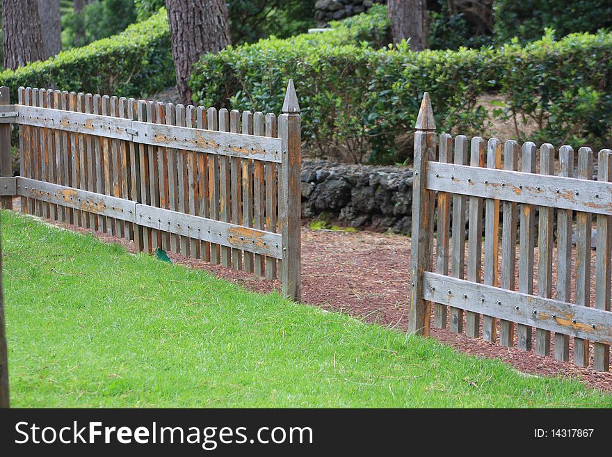 Wood fence delimitating grass park. Wood fence delimitating grass park