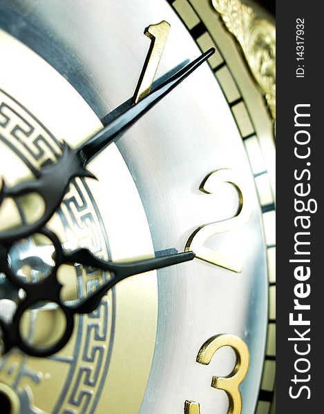 Close view of the hour and minute hands of an antique clock. Close view of the hour and minute hands of an antique clock