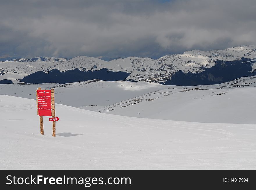 Valea Dorului, Sinaia, Romania ski resort view. Vast snow with beautiful clouds over the blue sky.