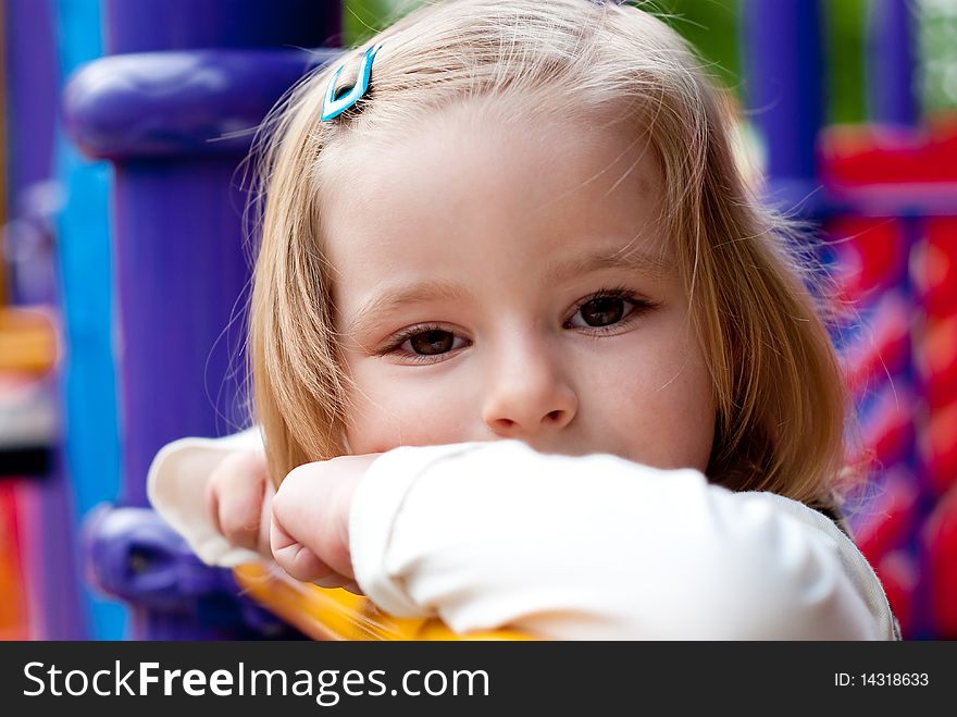 Little smiling girl in the playground.  Outdoor shot. Little smiling girl in the playground.  Outdoor shot