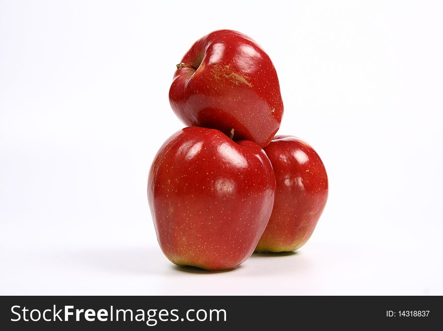 Three red apples in a stack on white background. Three red apples in a stack on white background