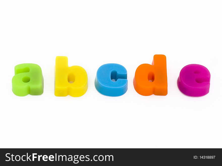 Colorful magnetic fridge magnet letters on a white background. Colorful magnetic fridge magnet letters on a white background